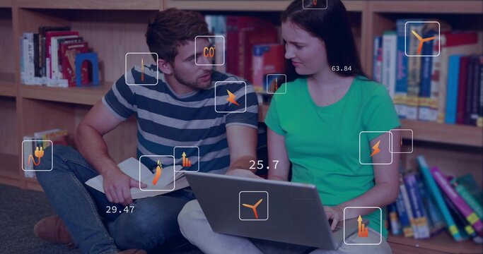 Studying two students in striped and green shirts in library, using laptop and notes with overlay