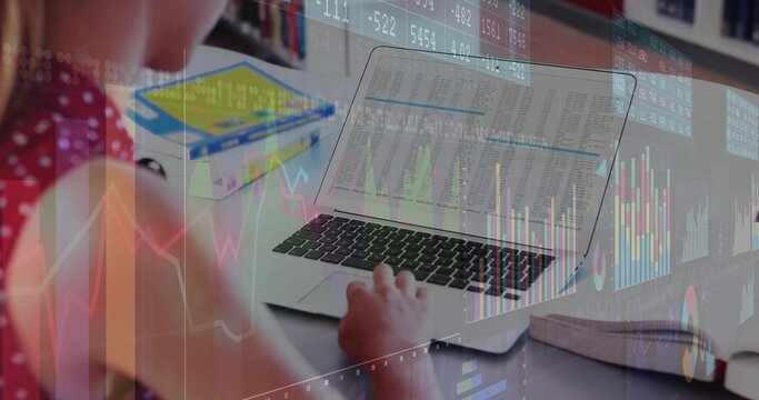 Typing student in red polka dot top at desk, laptop, books, notebook, charts, copy space