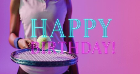 Holding athlete balancing tennis ball on racket in studio, wearing tank top, neon HAPPY BIRTHDAY