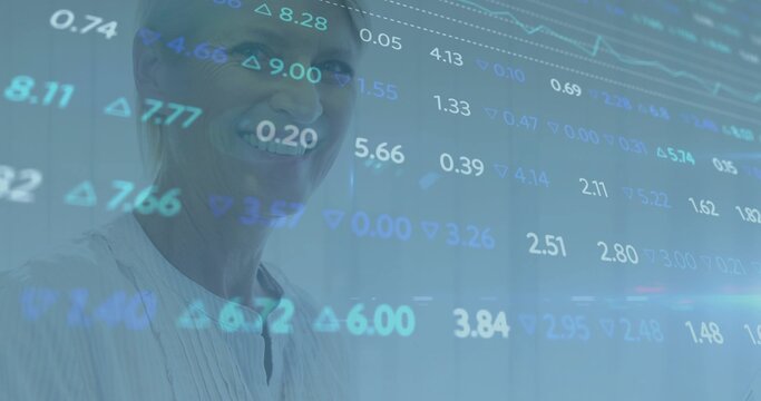 Smiling senior woman wearing light collared blouse viewing projected financial data in office