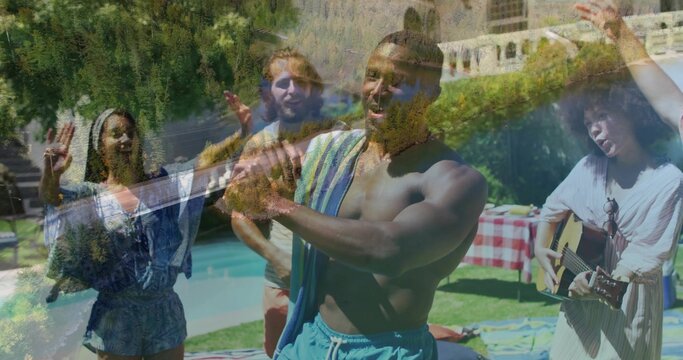 Clapping shirtless man in blue swim shorts with striped towel dancing at backyard pool, with guitar - Powered by Adobe