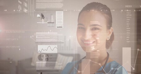 Smiling medical clinician in blue scrubs with stethoscope viewing HUD charts in clinic, copy space