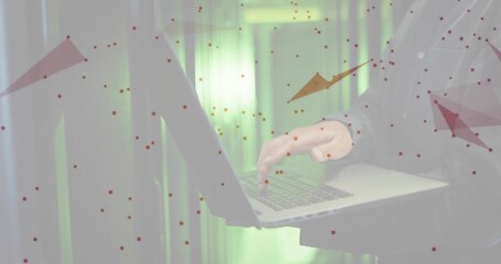 Typing on silver laptop, Korean man in server room in suit jacket, white shirt, red overlays