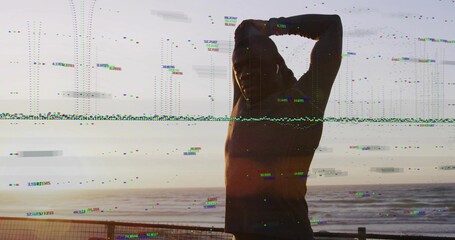 Standing man in dark hoodie and pants stretching on sea walkway by railing, glitching, copy space