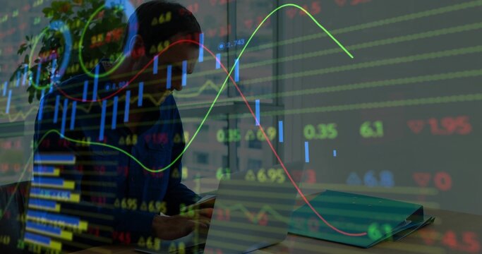 Comparing man in dark sweater checking smartphone, open laptop and binder near window with charts - Powered by Adobe