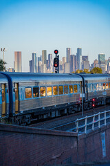 Obraz premium Melbourne city skyline with Metro train passing by, Skyline CBD Melbourne, View of Melbourne from Footscray.