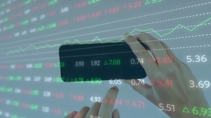 Woman holding phone horizontally, left finger tapping to monitor projected stock charts over hands - Powered by Adobe