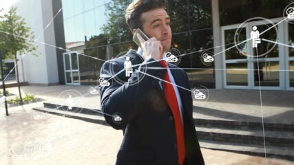 Business man walking by doors speaking on phone, call causing network overlay expanding around him - Powered by Adobe
