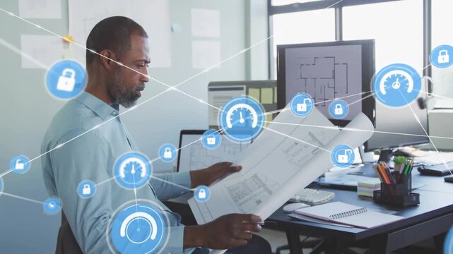 Architect studying plans, monitor showing plan starting blue icons connecting for analyzing plans
