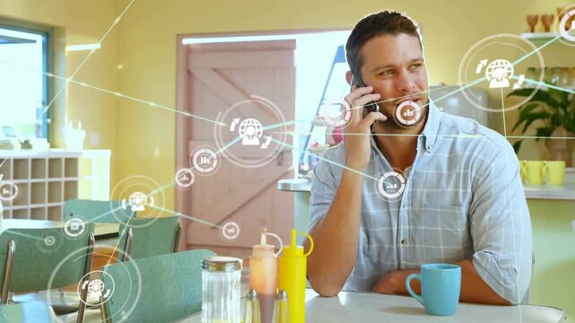 Man sitting in kitchen holding phone, animated network starting by condiments and showing tech data