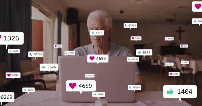 Senior man watching laptop, social likes growing on screen, spurring typing and smiling to engage