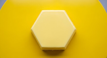 Close-up of a yellow hexagon on a yellow surface.