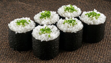 Japanese maki sushi rolls with rice, nori, and fresh chives on mat