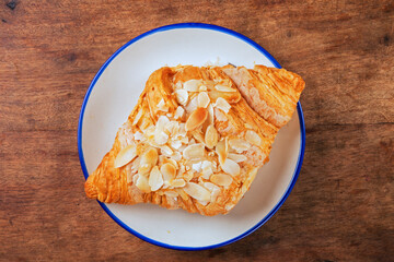 Almond butter croissant on white plate   