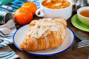 Almond butter croissant on white plate   