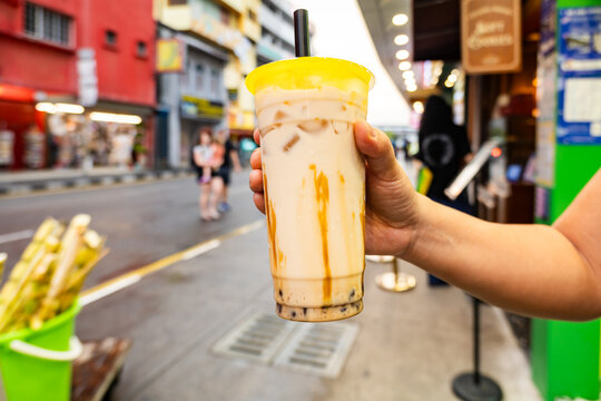 Bubble Tea, or Taro Milk tea, cup on the street in Asia. Bubble Tea is a tea-based drink most often containing chewy tapioca balls