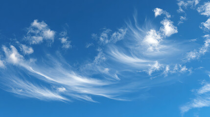 Beautiful wispy clouds in a bright blue sky, creating a serene and peaceful atmosphere perfect for relaxation.