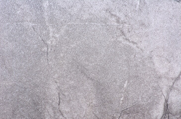 Gray marble, a polished surface of natural light-colored stone with black veins.