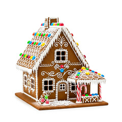 Decorated gingerbread house with candy canes and colorful candies display on white background