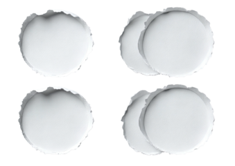 Four white, crimped metal bottle caps on black