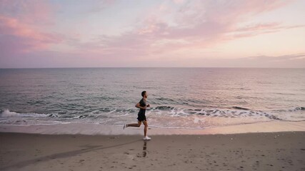 Man jogging along a tranquil beach at sunset, with gentle waves lapping the shore and a pastel-colored sky reflecting on the wet sand