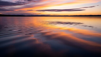 Obraz premium Sunset Over Calm Water with Colorful Sky Reflections in Tranquil Natural Landscape