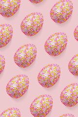 Repeat design of glossy eggs over pink background, creative flat lay from decorative sparkly Chicken egg, minimal pastel pattern, for packaging, social media display, Easter food celebration concept.