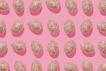 Decorative easter eggs in colored sequins as minimal pattern pastel pink tone, sunlight shadow. Pop art still life photo with sparkling rhinestones eggs, spring easter holiday concept, modern design.