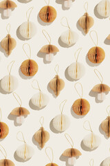 Stylish Paper Christmas Ornaments, hanging ivory beige New Year decorations as mushrooms, balls, flashlights, sunlight shadow, minimal aesthetic holiday flat lay, festive top view patterns background