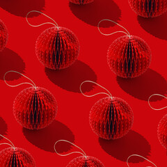 Festive creative red pattern of paper Christmas ornaments on red with hard shadow, minimal monochrome holidays layout. Geometric texture of paper Honeycomb balls. Christmas and New Year greeting cards