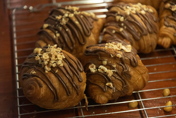Close up photo of tray of golden brown, flaky and look freshly baked croissants in bakery.