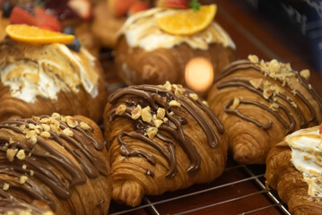 Close up photo of tray of golden brown, flaky and look freshly baked croissants in bakery.