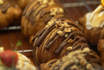 Close up photo of tray of golden brown, flaky and look freshly baked croissants in bakery.