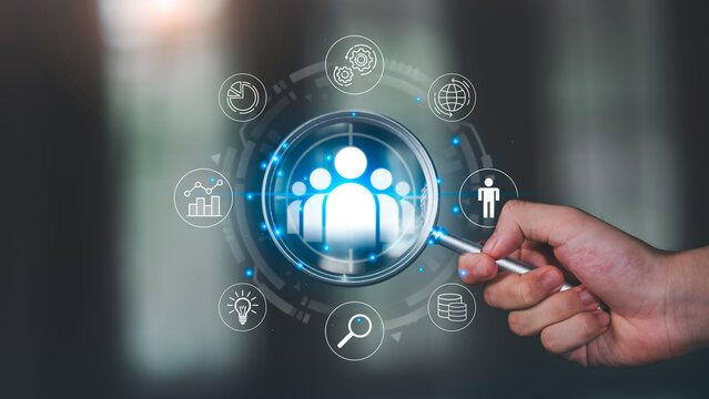 magnifying glass highlights digital customer group icon surrounded by data analytics, targeting symbols, business insights, emphasizing customer analysis, segmentation, strategic marketing decisions