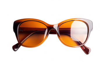 Stylish oversized sunglasses with a warm amber tint resting on a clean white surface. their elegant design and modern aesthetic. ideal for fashion and accessory promotions