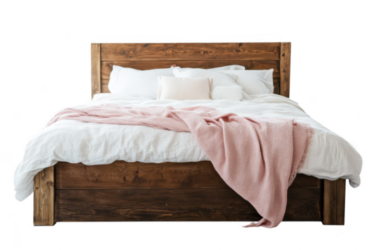 A beautifully styled wooden bed with a soft pink throw blanket and plush pillows. set against a clean white background. ideal for home decor or interior design ideas
