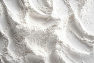 Obraz premium close-up of fine white flour spread into soft flowing ridges and valleys creating a calming tactile abstract texture