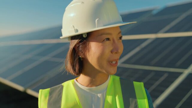 Renewable energy worker inspects solar panels at a sunny site in California, focusing on sustainability efforts