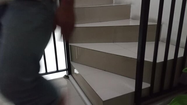 A man is going up and down the stairs barefoot.