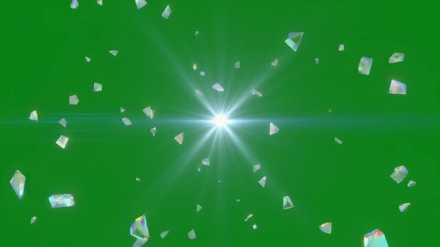 Bright light burst with sparkling crystal shards exploding outwards on a green screen background.