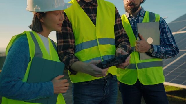 Experts discuss solar energy project during site visit in sunny weather