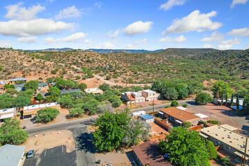 colorful aerial perspective showcasing suburban charm amid rolling foothills and clear blue sky