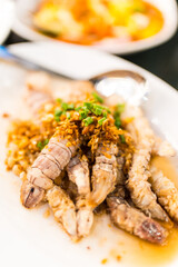 Mantis shrimp stir with garlic served on a white dish, Thai style seafood