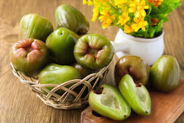 Beautiful and healthy display of freshly harvested Jambu Air Hijau (Green Water, Rose, Wax apples) in a basket, perfect for a snack or dessert.