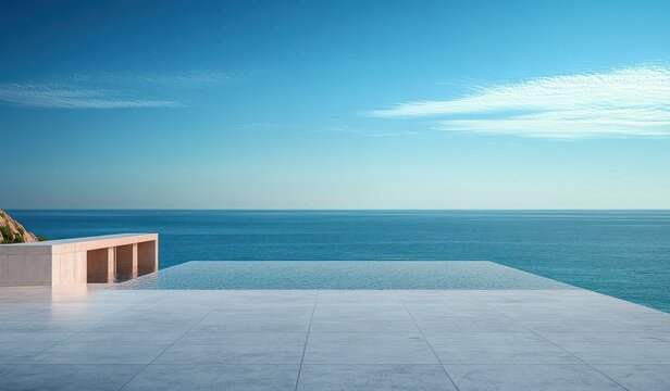 Minimalist infinity pool and tiled terrace with low concrete bench overlooking calm blue sea, distant rocky outcrop and clear sky with wispy clouds, evoking serene relaxation