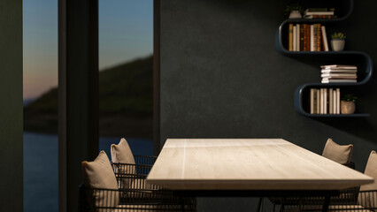 Wooden table with metal chair with glass window and hanging bookshelf on dark green wall in dim room