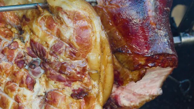 Roasting Pork Knuckle on Spit Over Open Wood Fire
