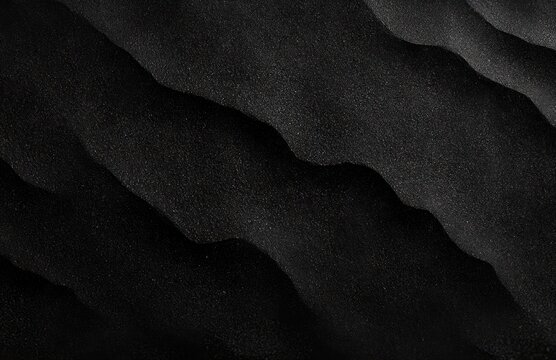 close-up of rippled black sand forming layered wavy dunes with granular texture and a moody, minimal abstract atmosphere - Powered by Adobe