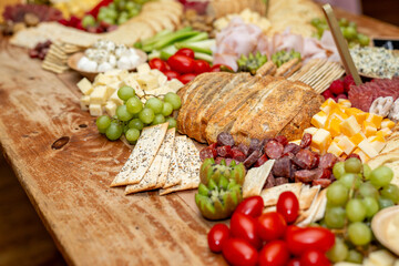 Large Charcuterie Board at an event with variety of finger foods	
