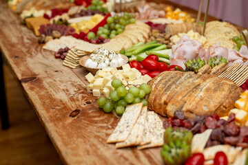 Large Charcuterie Board at an event with variety of finger foods	
